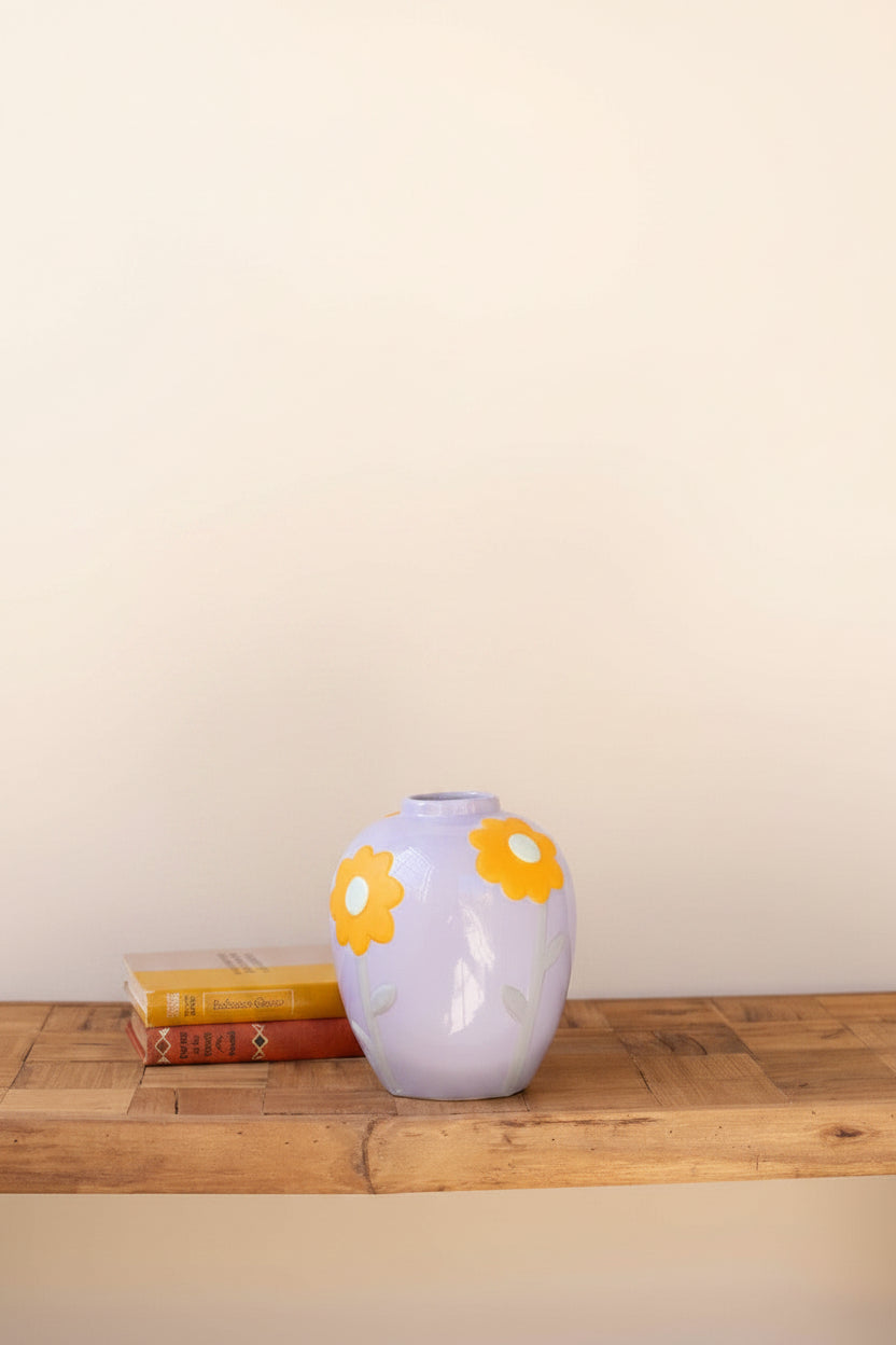 small lavender vase with bright orange flower design