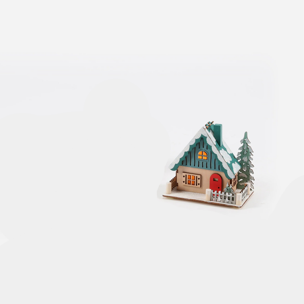 small house ornament with green roof, red door, and tree