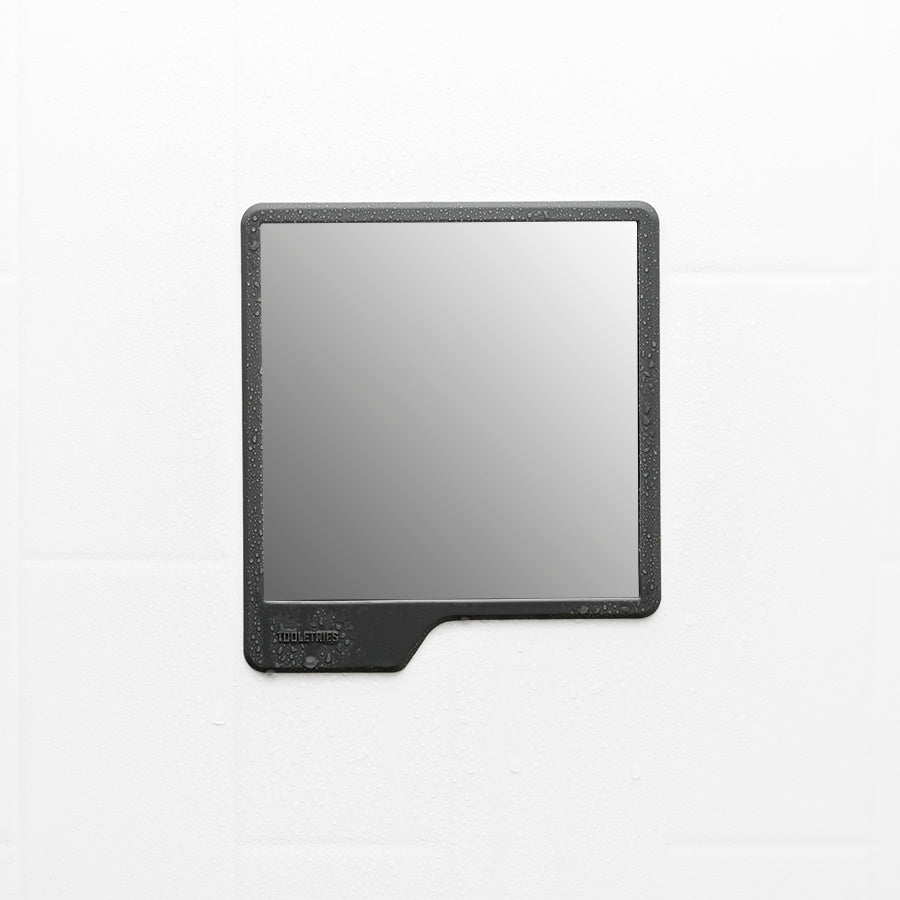 shower mirror on a white tile background.