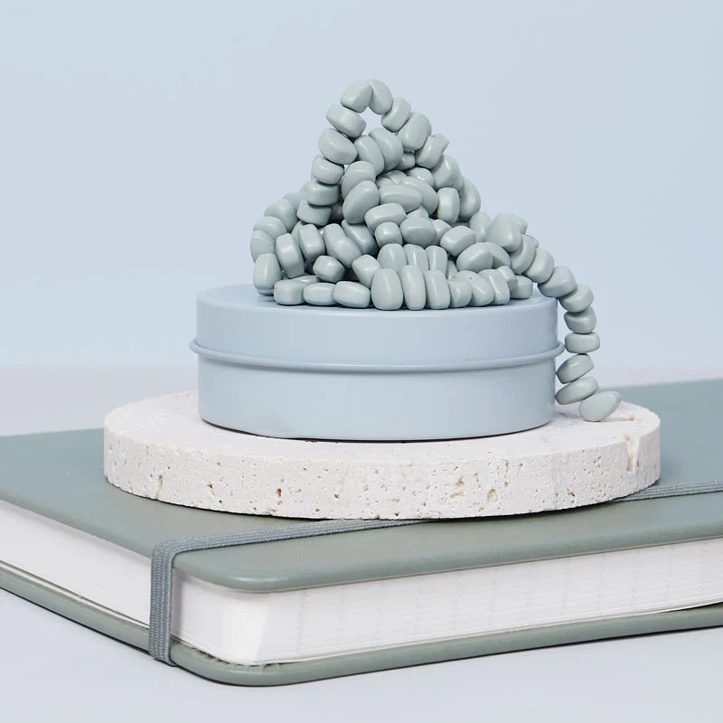 sage crags set on a stone disk on a book
