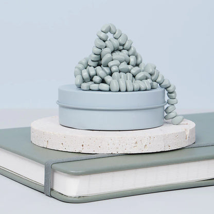 sage crags set on a stone disk on a book