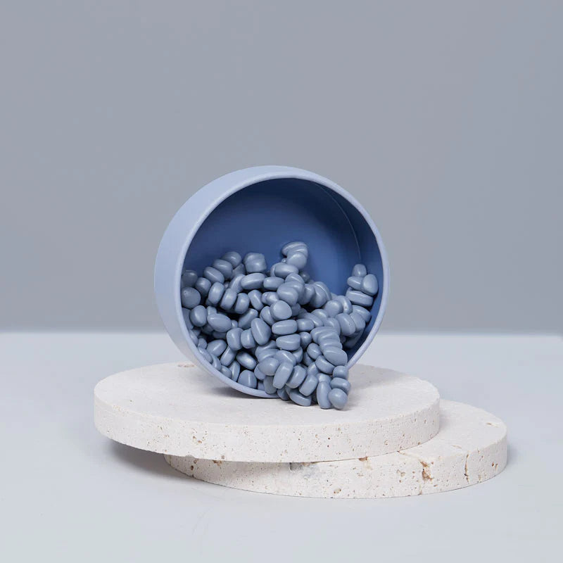 Slate crags spiling out of the slate colored tin onto stone circles