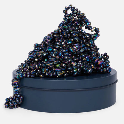 pile of iridescent magnetic stones on a tin