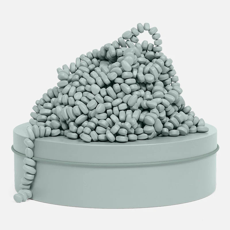 pile of sage green magnetic stones on a tin