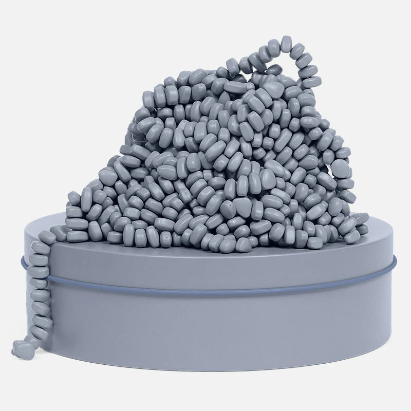 Slate crags piled on top of the slate colored tin on a white background