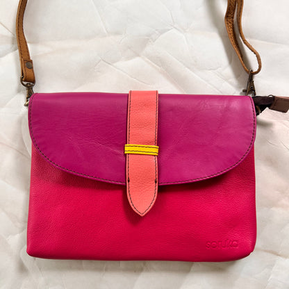 saddle bag with crossbody strap attached.