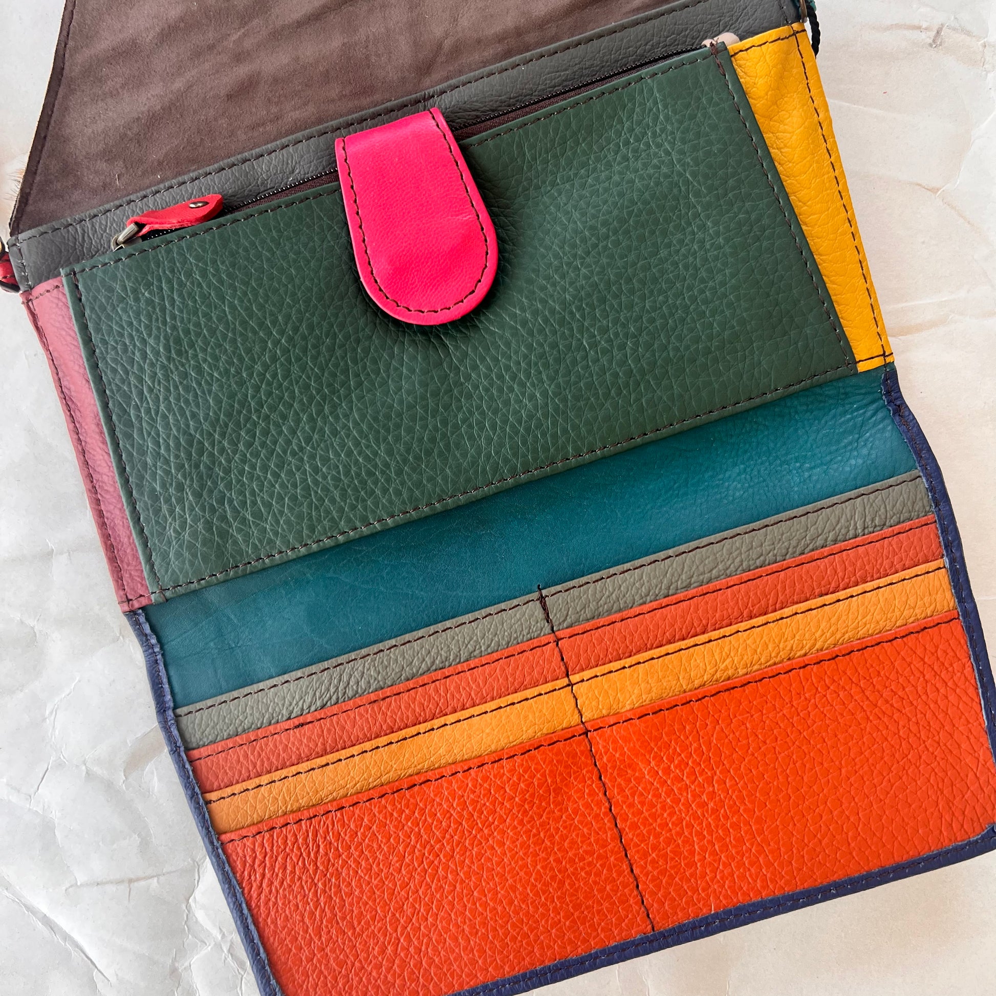 interior view of secret clutch wallet showing colorful card slots and other pockets.