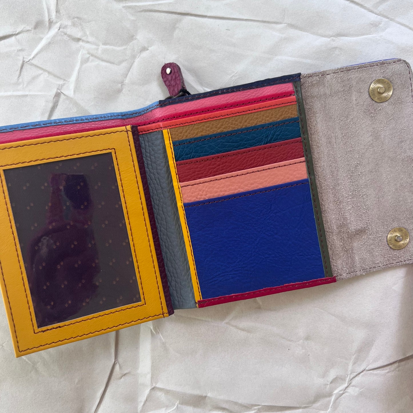 periwinkle rings wallet laying open showing colorful card slots