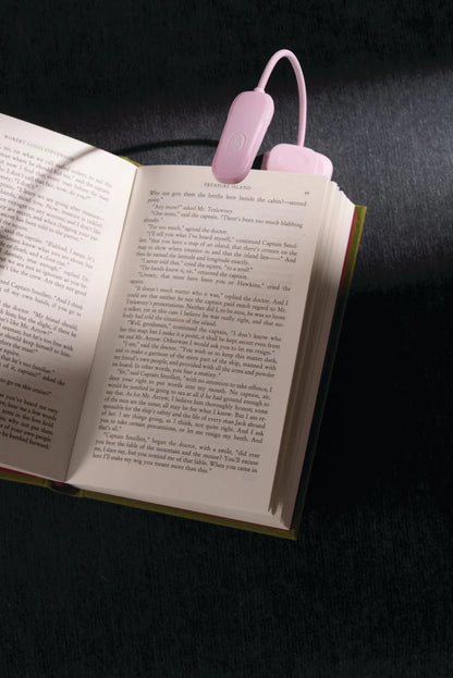 lilac Book Light turned on a clipped to a book