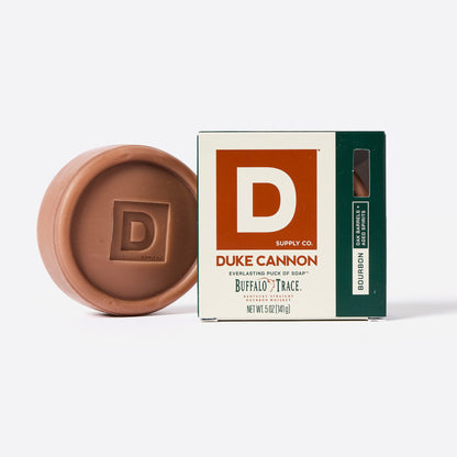 bourbon scent soap puck next to its box on a white background