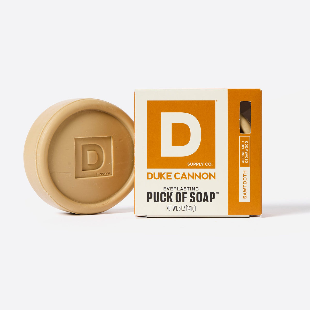 Sawtooth scent soap puck next to its box on a white background