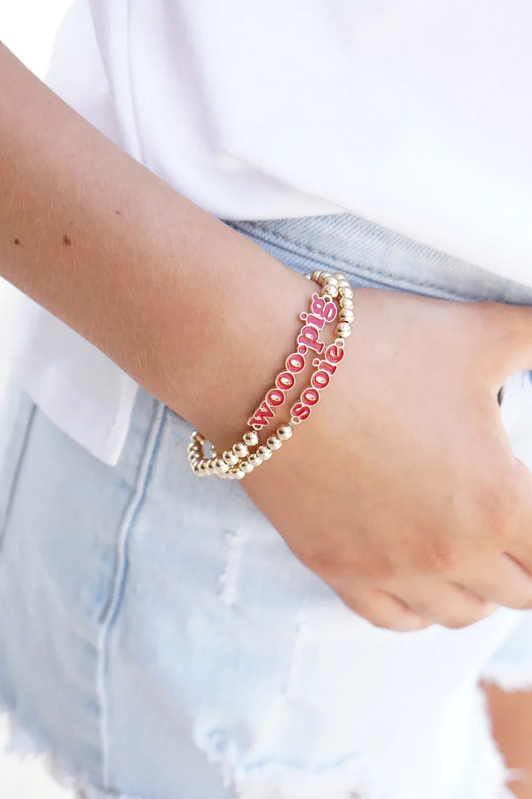 Arkansas Razorbacks WoooPig Sooie Bracelets on someone's wrist 