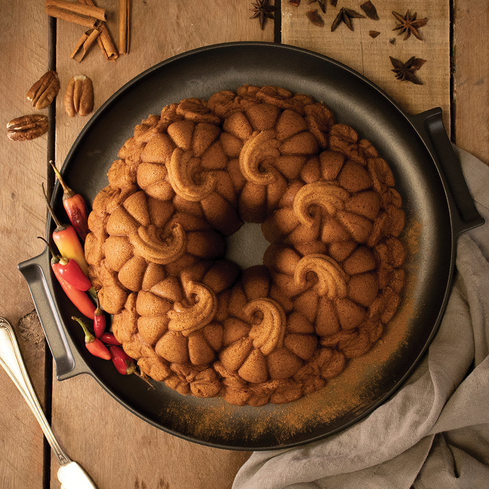 top view of baked pumpkin patch cake on a platter on a wooden table.