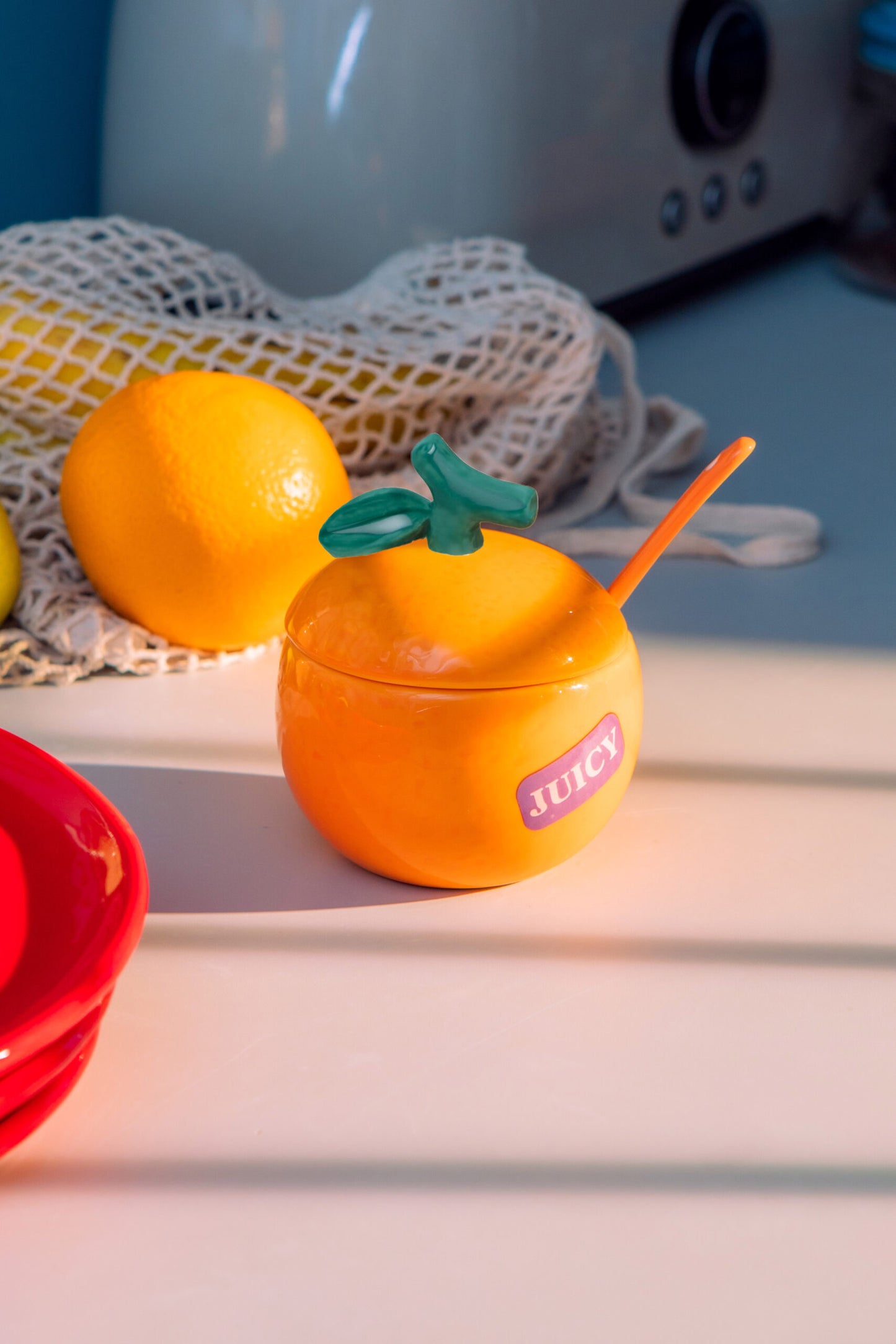 orange shaped sugar bowl on a kitchen counter.