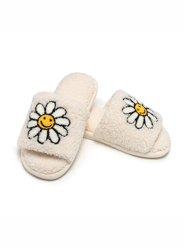 white slipper slides with daisies on them.