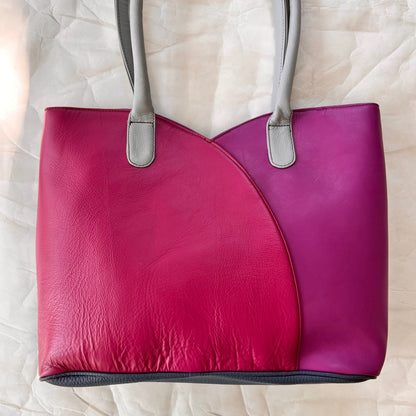 valeria tote that is half pink and half light plum with grey handles.