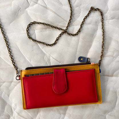 raspberry kimber wallet with crossbody chain attached.