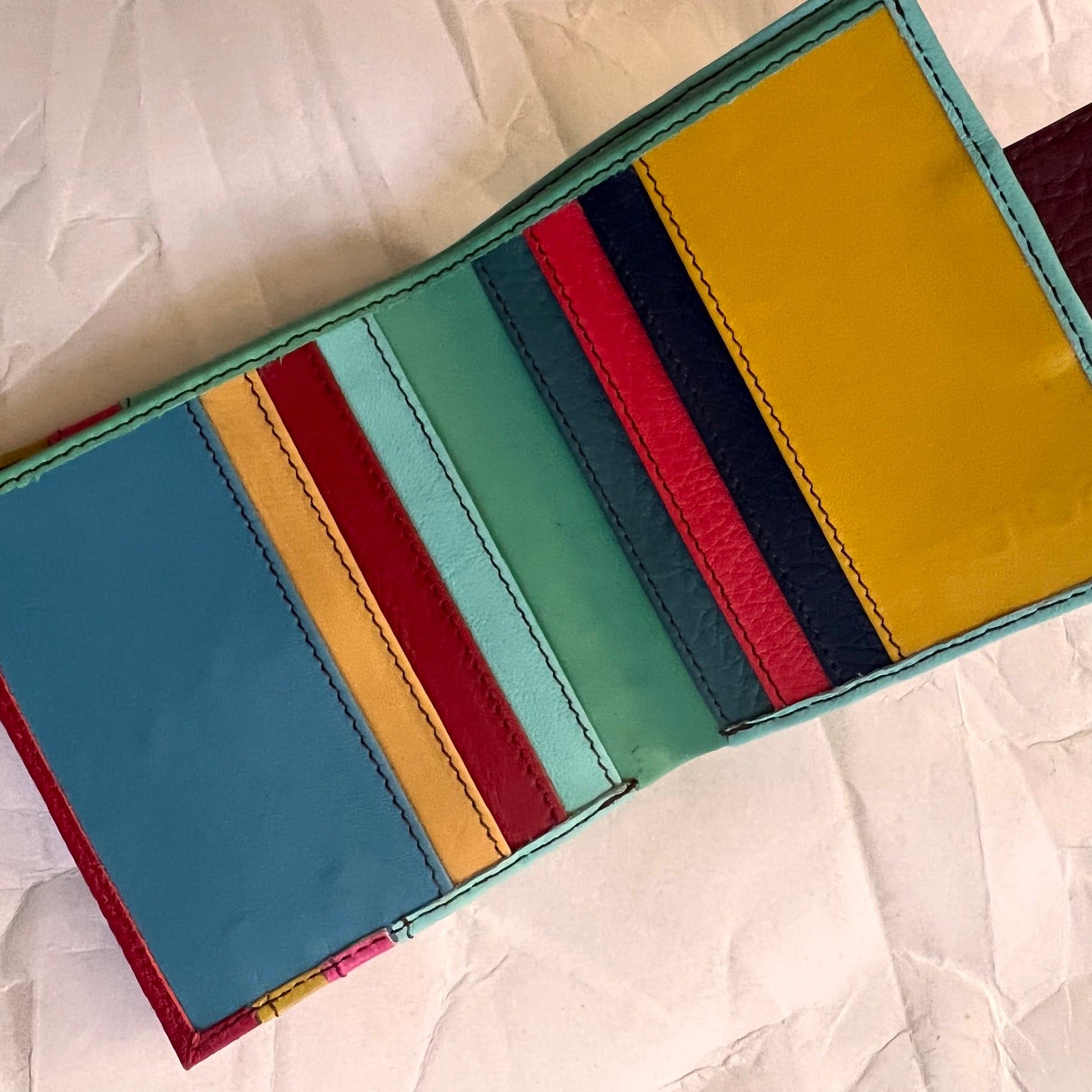 kelly wallet laying open showing multi-colored card slots.