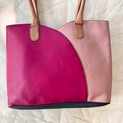 valeria tote that is half lilac and half bright pink with blush handles.