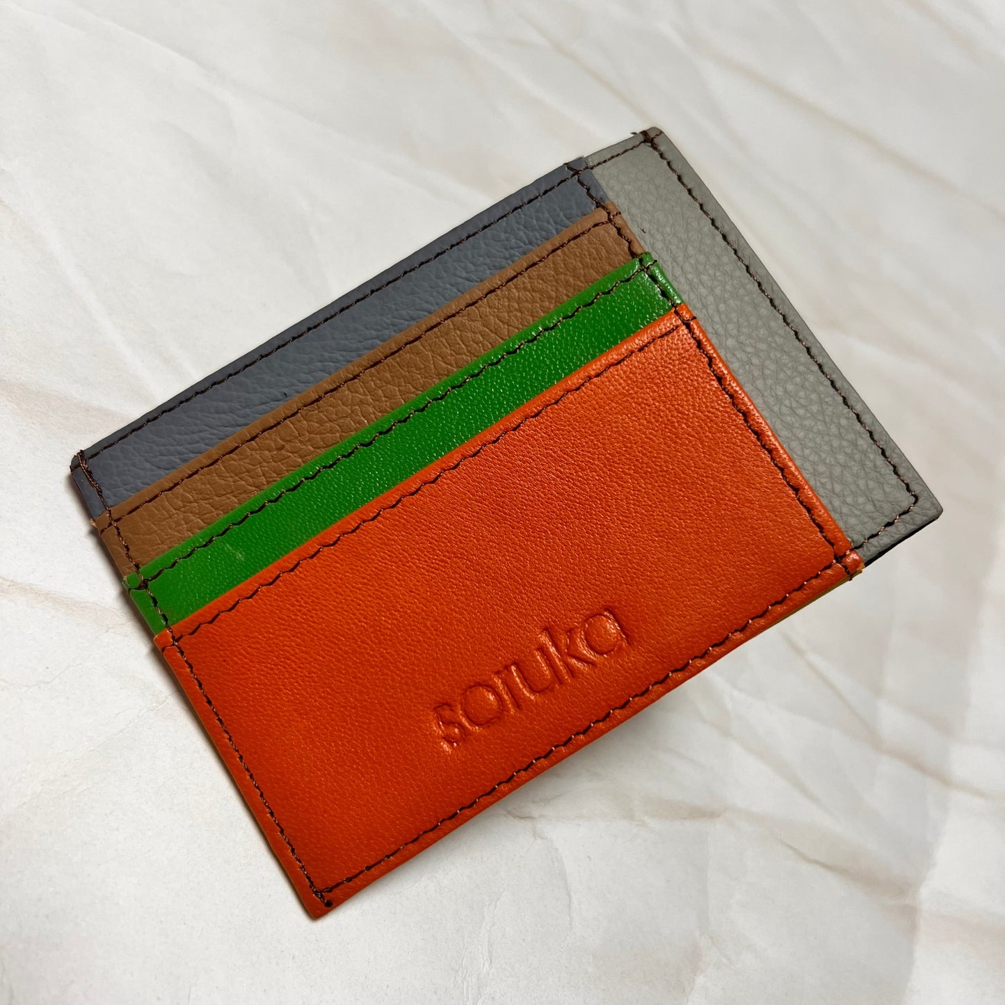 orange polly wallet with colorful card slots.