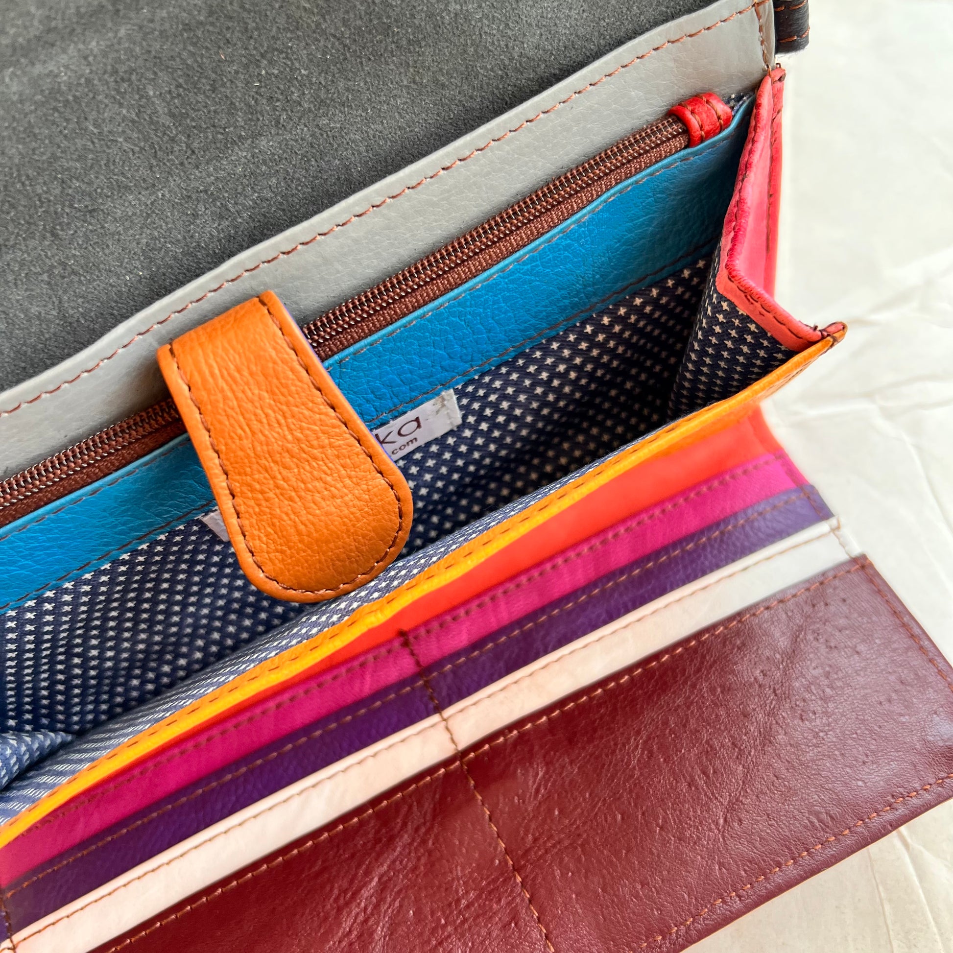 top interior view of berry secret clutch wallet with pocket open.