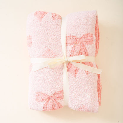 pink blanket with a pink bow pattern