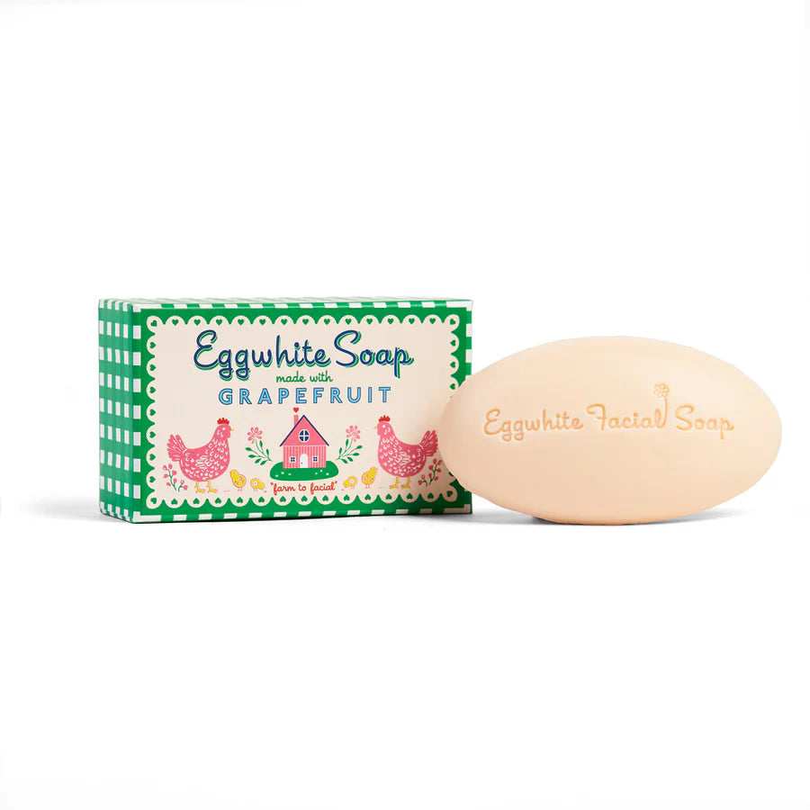 Oval bar of soap sat next to its green gingham box packaging.