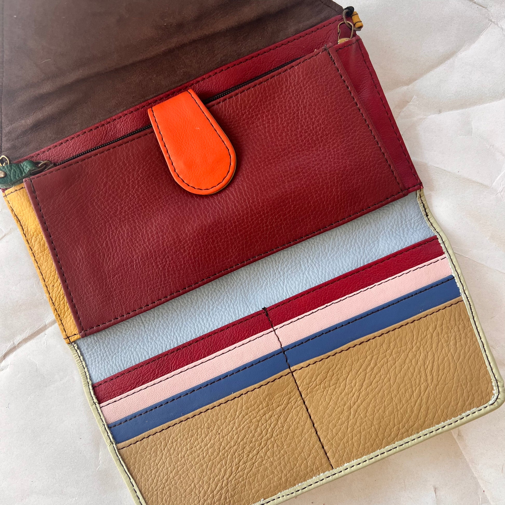 interior view of secret clutch wallet showing colorful card slots and other pockets.