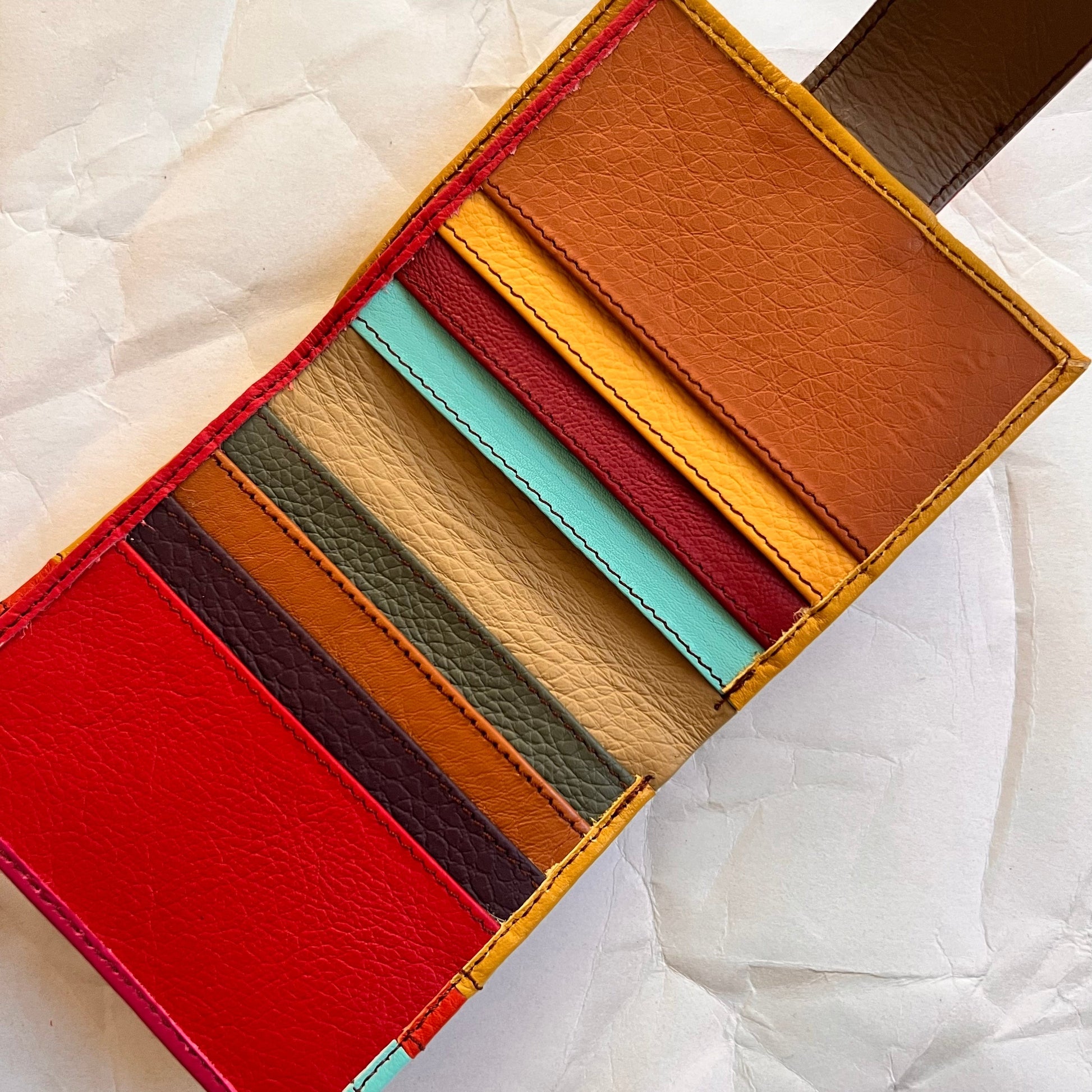 kelly wallet laying open showing multi-colored card slots.