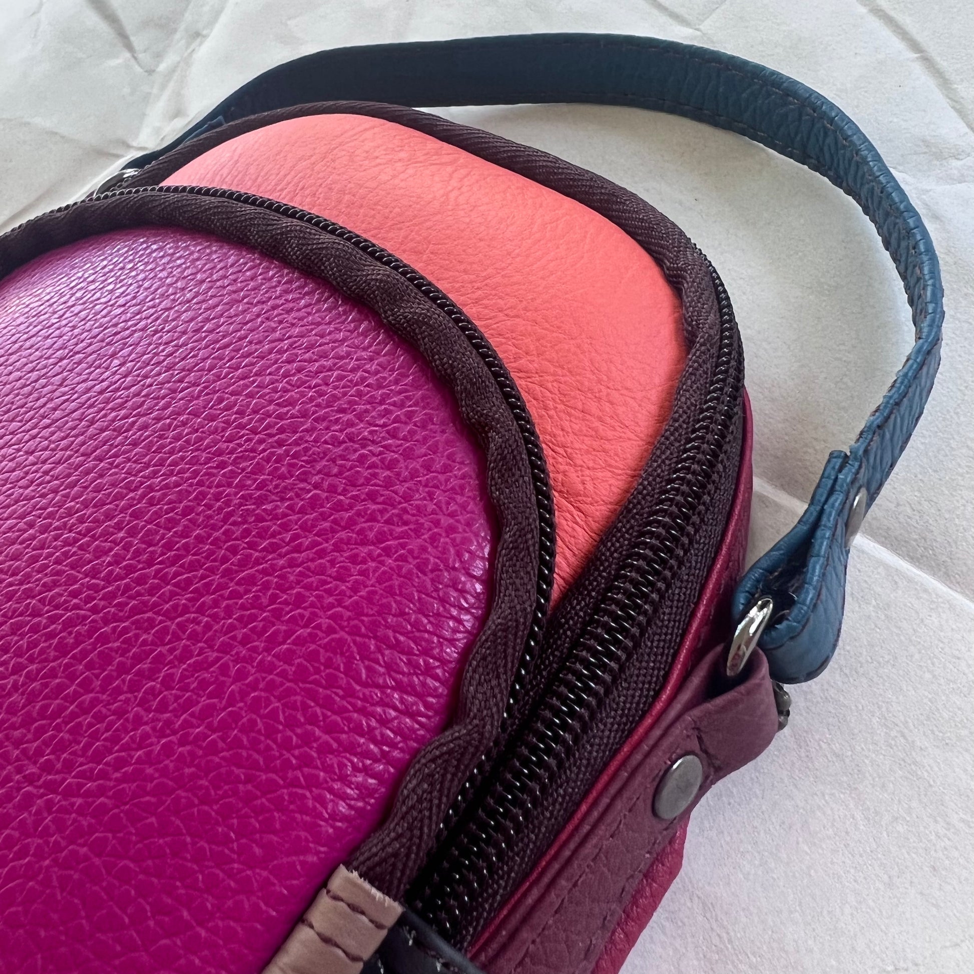close-up of top of Melon and fuchsia Ruth Small Backpack Crossbody