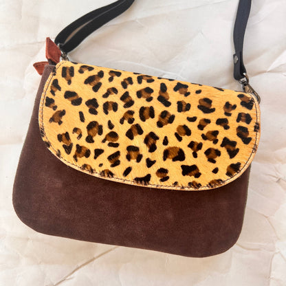 leo purse with a plum body and animal print flap.