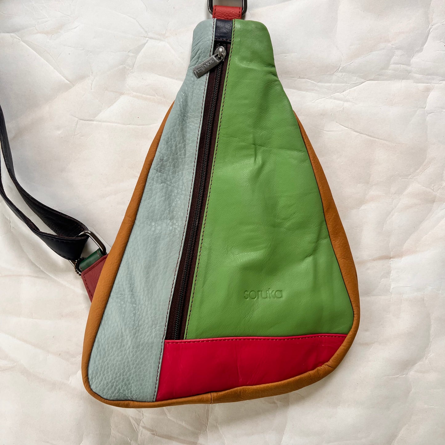 front view of seafoam roxi sling bag.