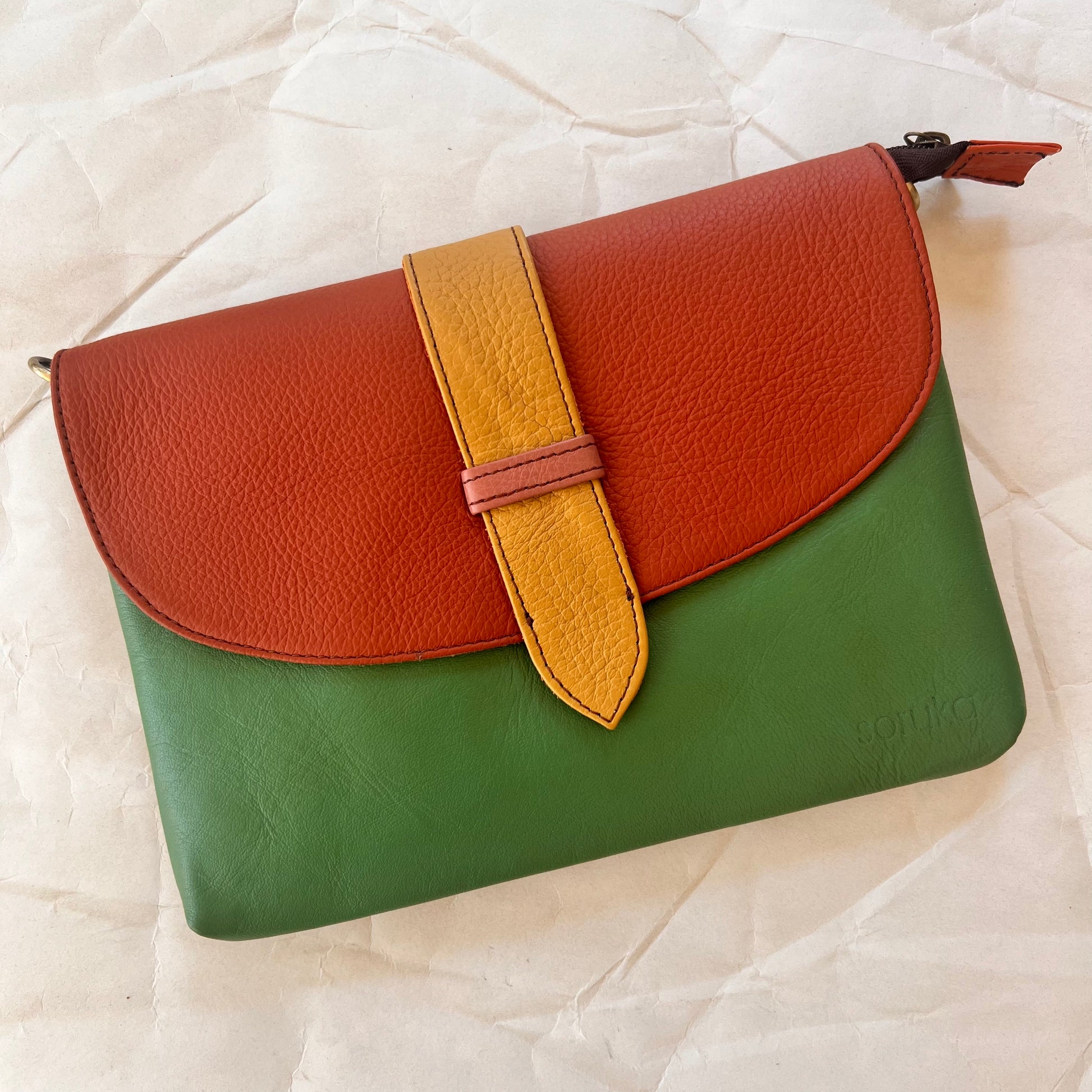 seafoam green saddle bag with ginger orange flap and mustard tab.