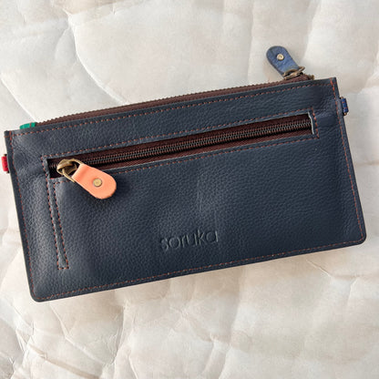 solid blue back of kimber wallet with zipper pocket.