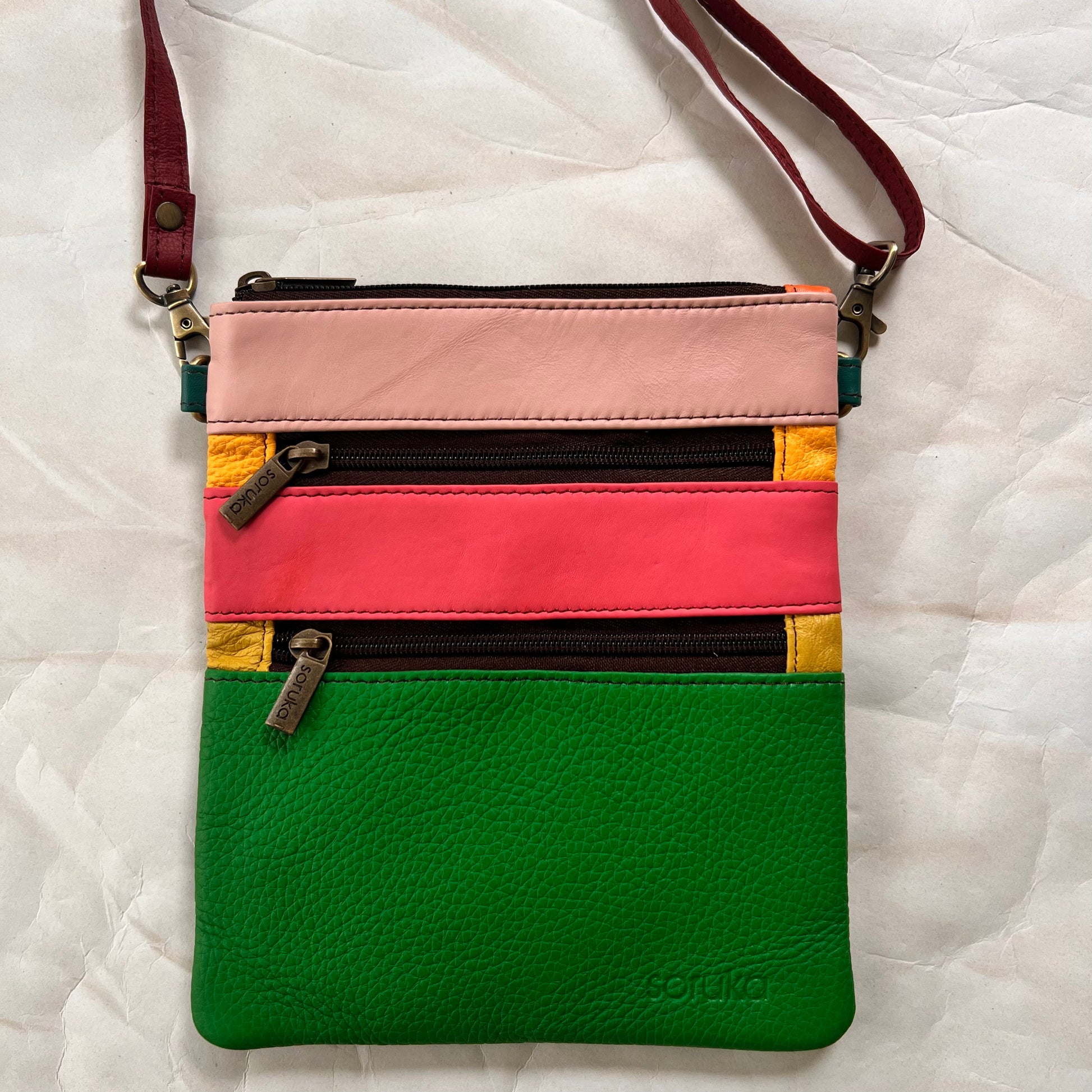 maya bag with crossbody strap attached.