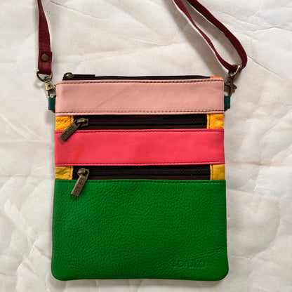 maya bag with crossbody strap attached.