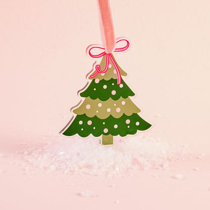 flat dark and light green acrylic ornament shaped like a treed shown on a pink background