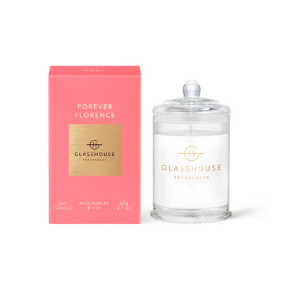 Forever Florence Triple Scented Candle sitting next to the pink box and displayed against a white background