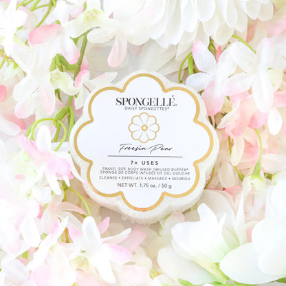 Spongellé product surrounded by white and pink flowers