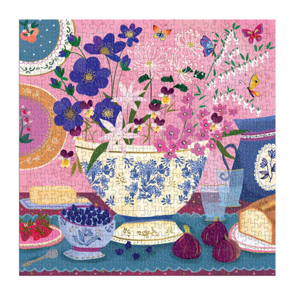 Colorful finished puzzle with floral and teacup design on a pink background