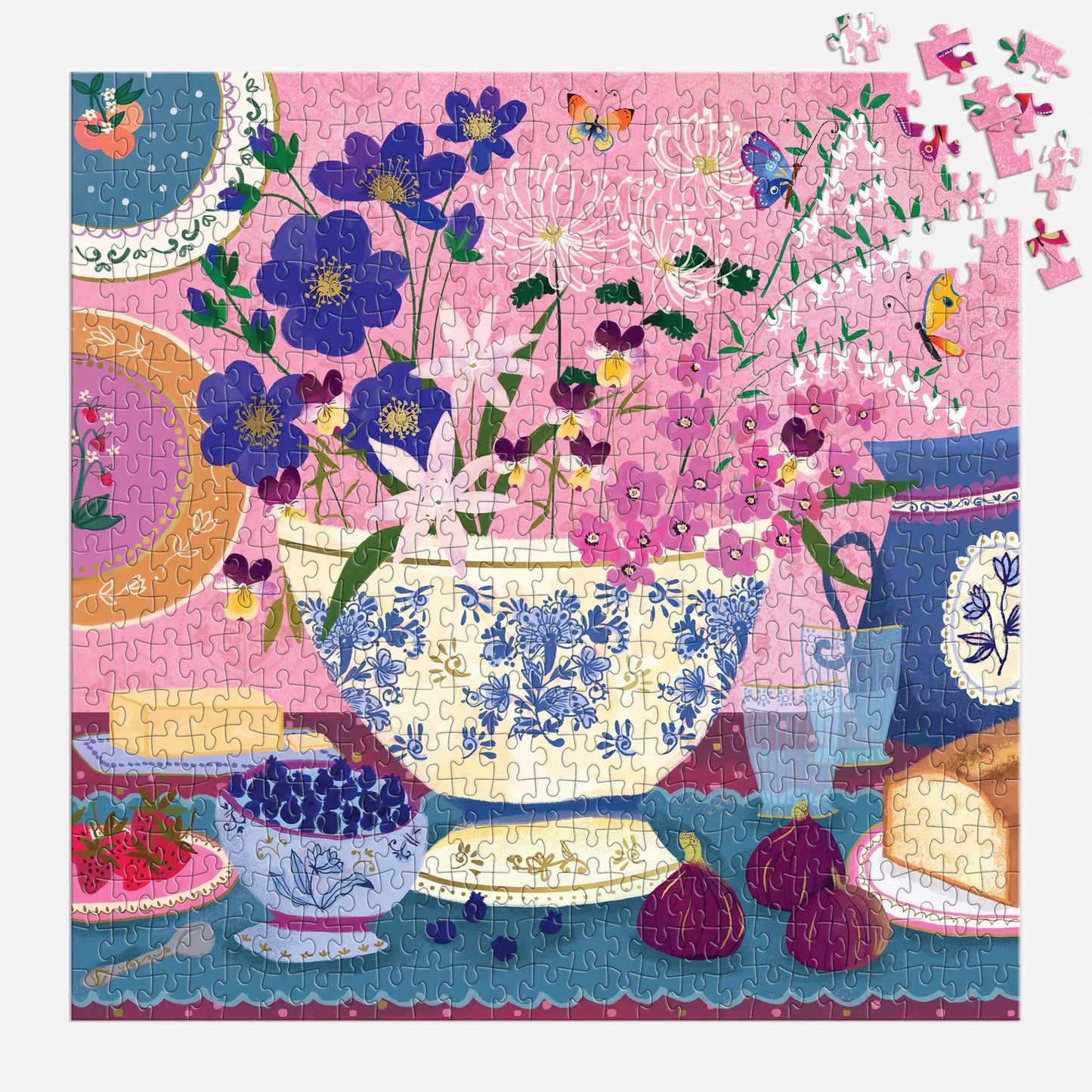mostly finished puzzle with floral and teacup design with a few of its pieces from the top corner scattered about