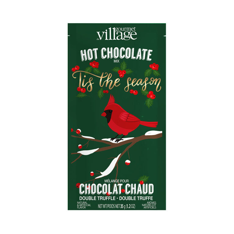 Gourmet Village hot chocolate mix packaging with a cardinal and holly design on a green background.