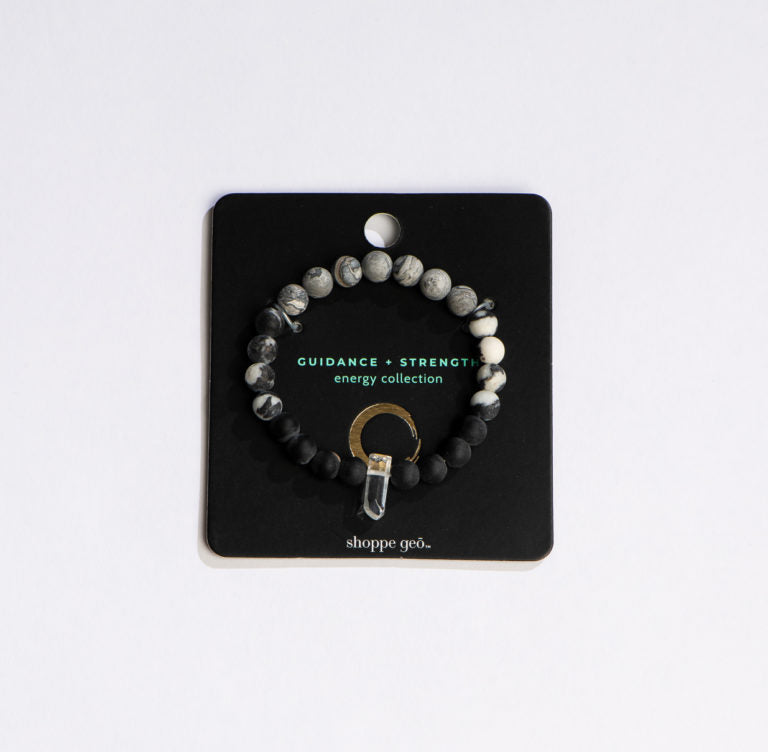 black and grey beaded bracelet with crystal on its card  packaging.