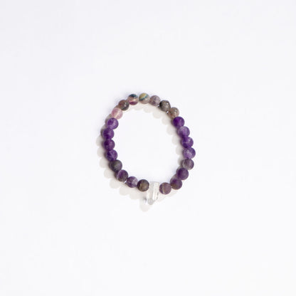 variety of purple crystal beads with clear crystal point bracelet on a white background.