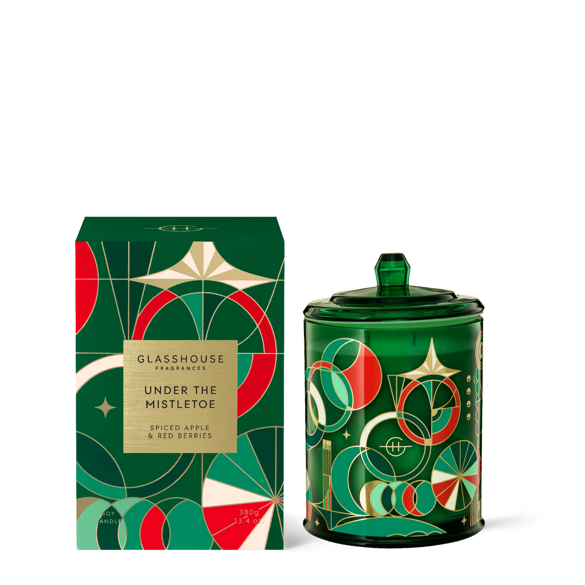 Under the mistletoe candle in green glass jar with Art Deco design set next to its box packaging.