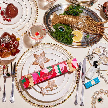 Table set with dishes and platters of food and a midnight in Milan bonbon.