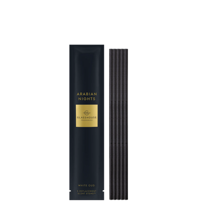 Arabian Nights scent stems set next to its black and gold packaging