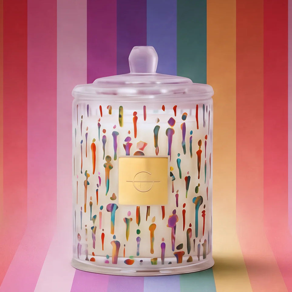 Candle with colorful design on a rainbow background