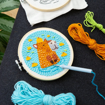 parts of the Capybara Punch Needle arranged on a black table