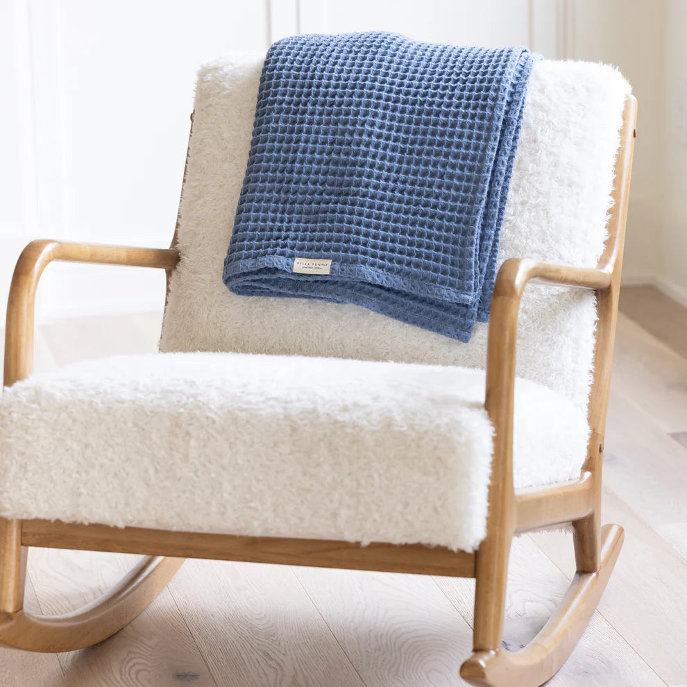 rain waffle blanket draped over the back of a rocking chair.